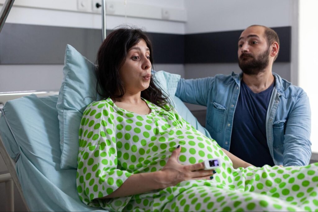 Doctor monitoring high risk pregnancy in hospital